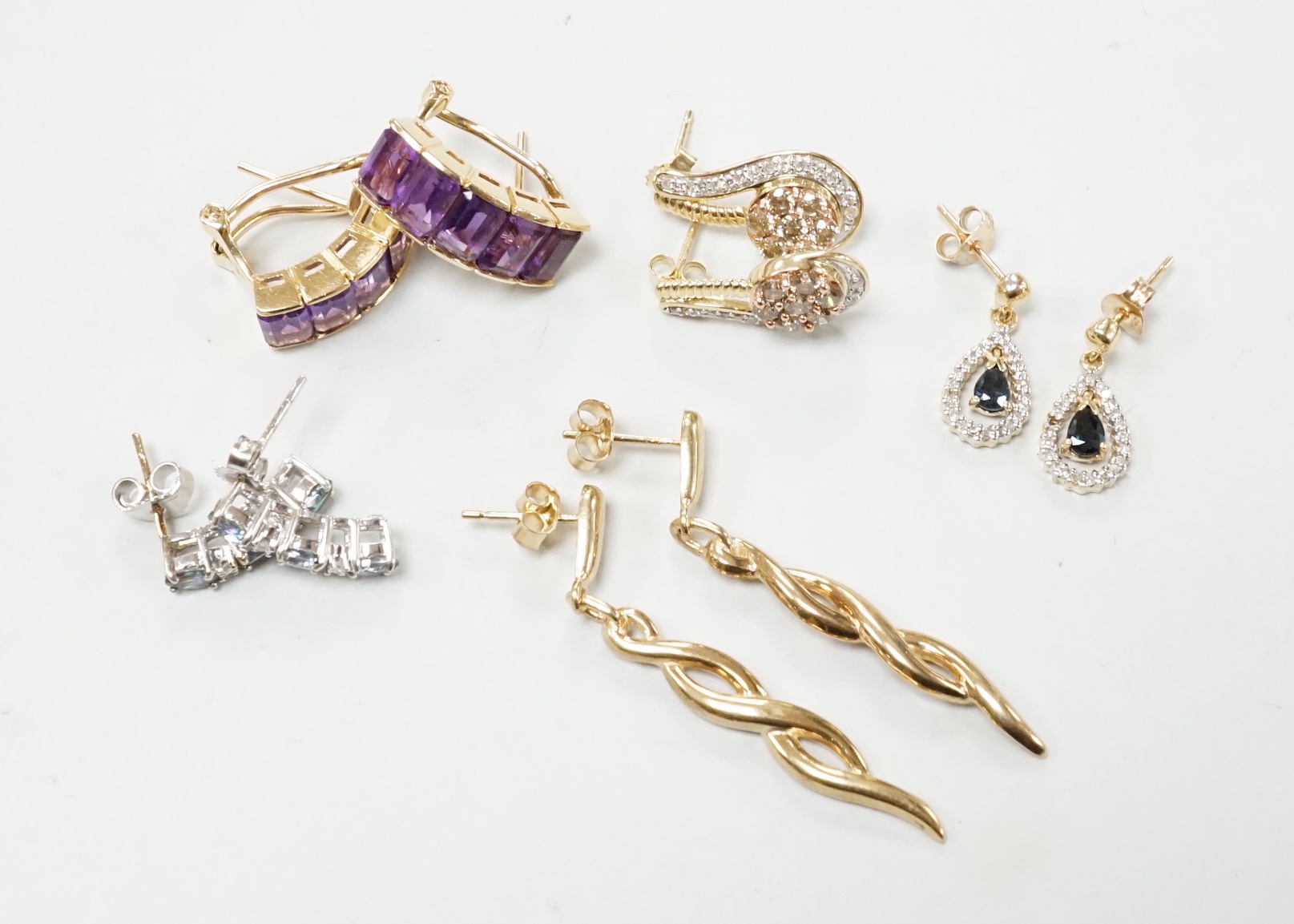 A modern pair of 585 yellow metal and five stone amethyst set demi lune earrings, 18mm, gross weight 6.2 grams, together with three modern pairs of 9ct and gem set earrings including two colour diamond cluster and one ot